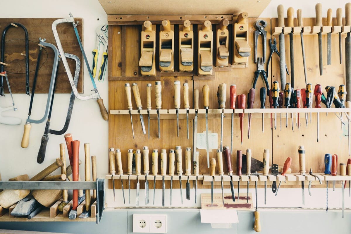 Assorted handheld tools in tool rack
