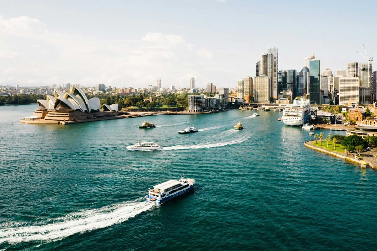 Aerial view of Sydney Harbour with the Opera House and ferries on the water