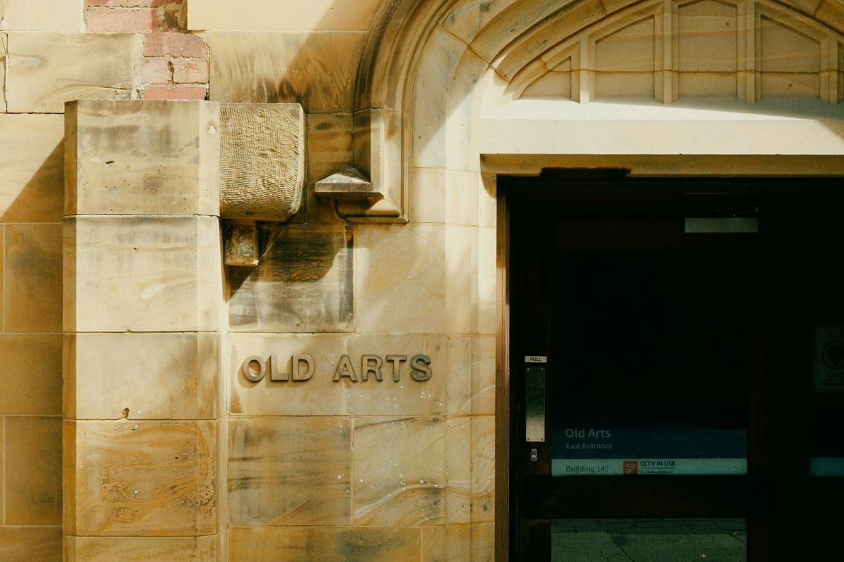 The sandstone entrance to the Old Arts building at the University of Melbourne in afternoon light