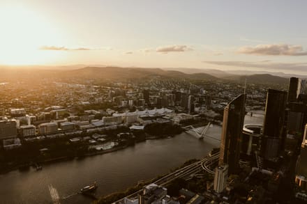 A warm Australian city skyline at late afternoon, calm and real, the kind of view you check after the paperwork is finally moving.