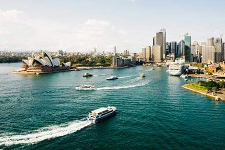 Aerial view of Sydney Harbour with the Opera House and ferries on the water
