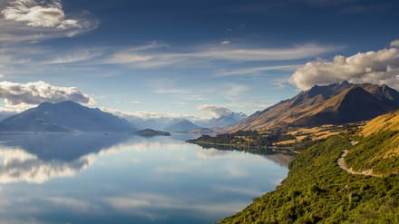Dry golden hills and a lake in the South Island high country, big and quiet.