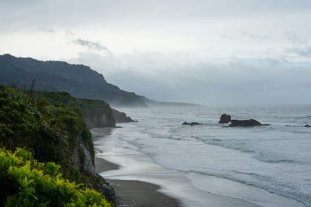 A view of a beach with waves coming in to shore