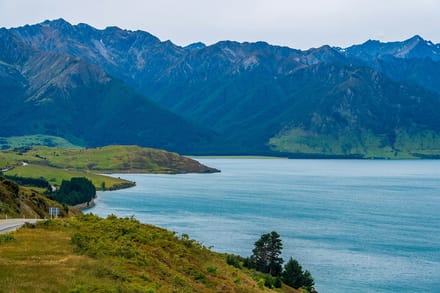 Lake Hāwea and mountains along a quiet South Island road