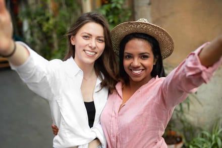 Two women arm in arm, laughing together