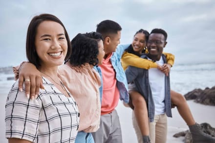 A group of friends laughing together on a beach